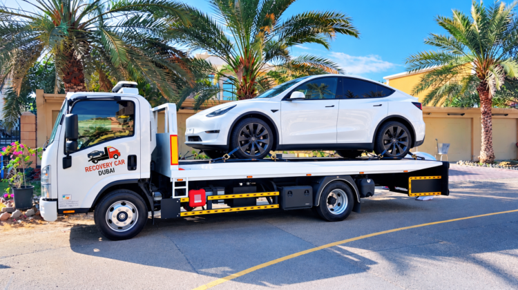 Electric car recovery Dubai: EV loaded on a flatbed tow truck
