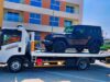 Car towing Dubai cost – flatbed tow truck loading an SUV
